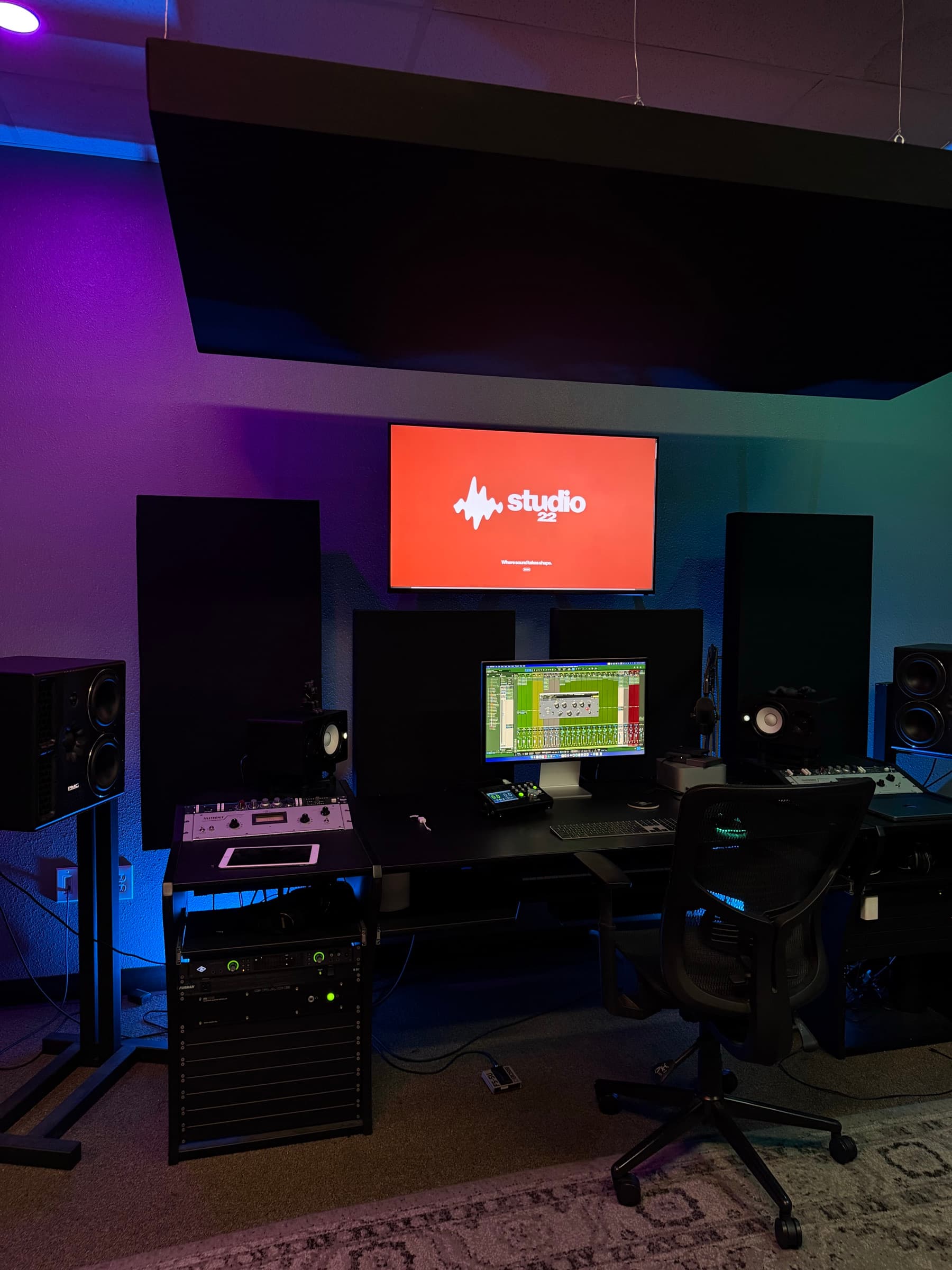 Studio 22 control room with dual monitors and red Studio 22 display