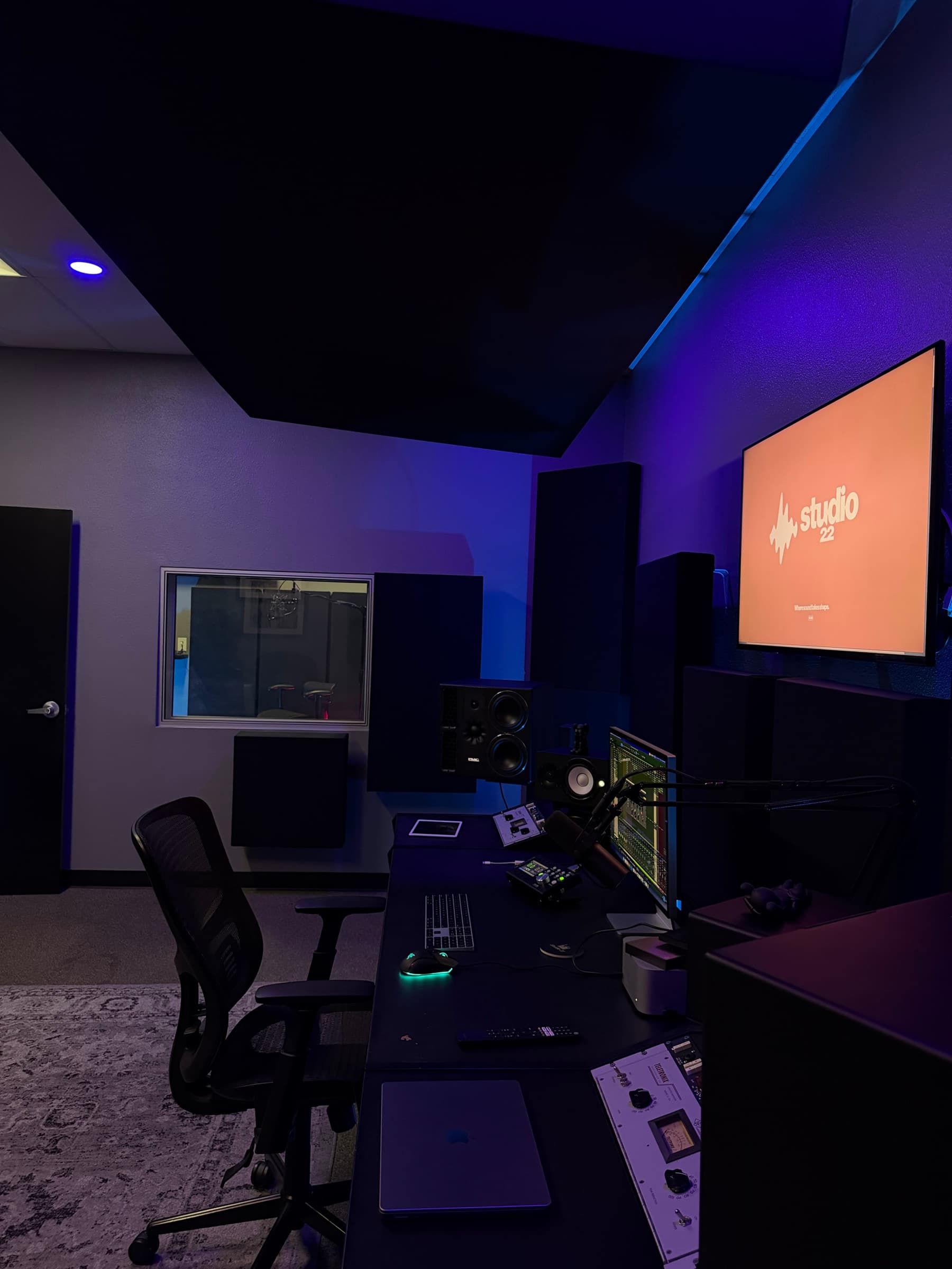 Side view of the Studio 22 control room, desk, and acoustic treatment